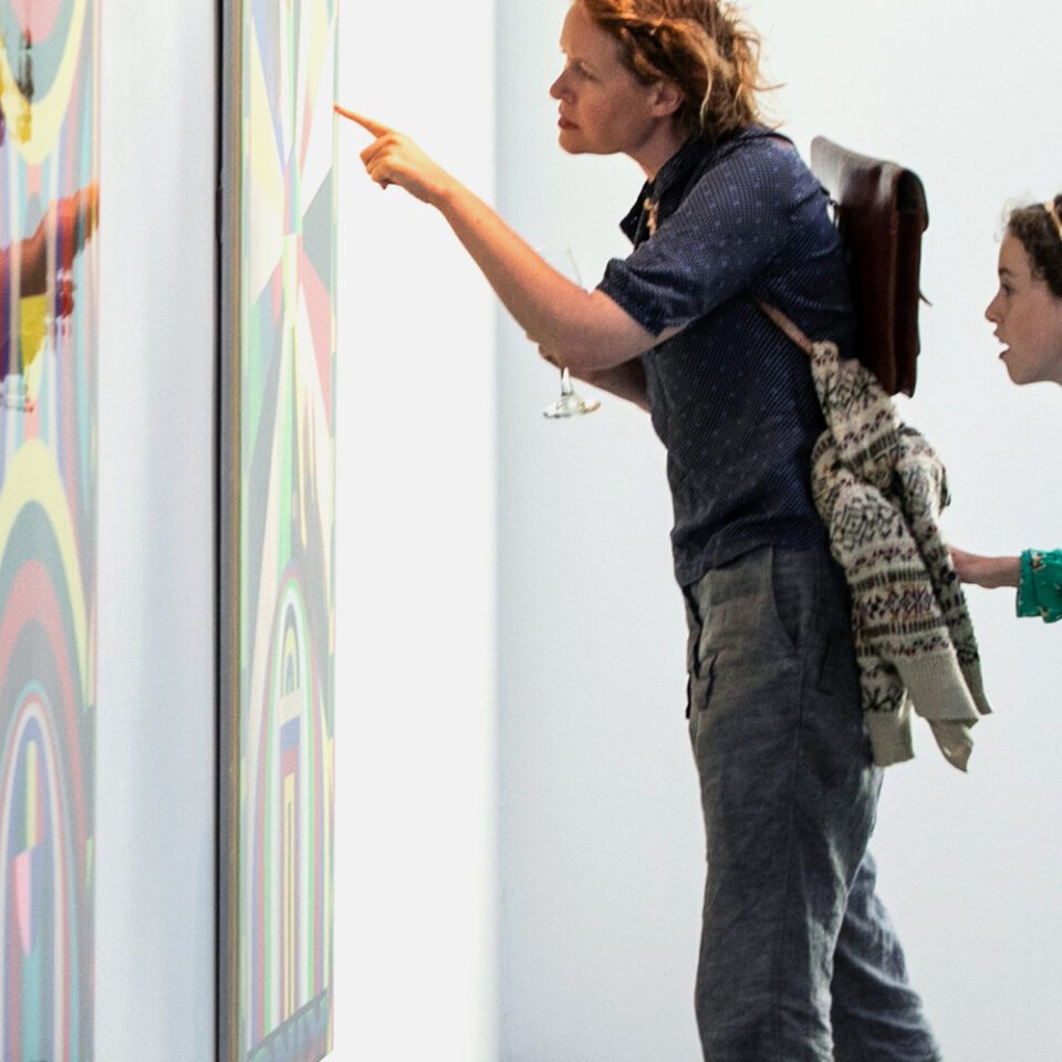 Mother and daughter looking at some artwork