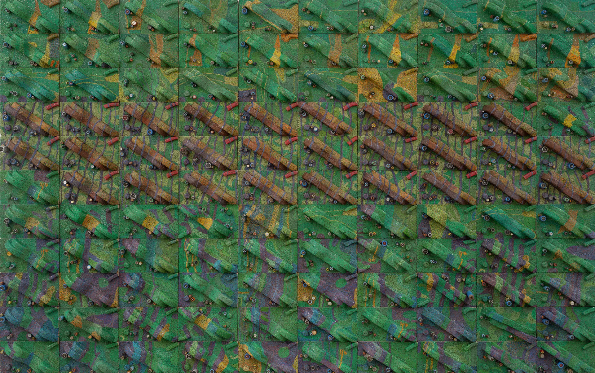 A colour photograph of Elias Sime's three-dimensional wall piece that looks like an aerial view of maps, with a layered texture made from wires and other components in shades of greens, yellow, blue, purple, brown and red.